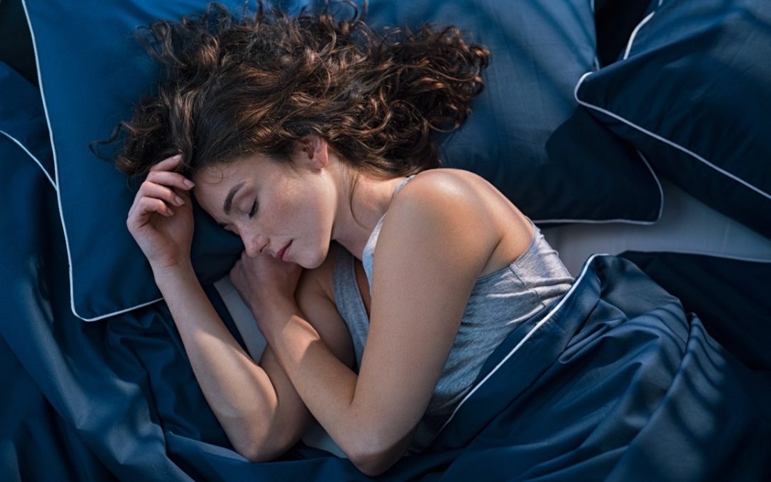 Woman sleeping peacefully, illustrating the connection between sleep and skin health