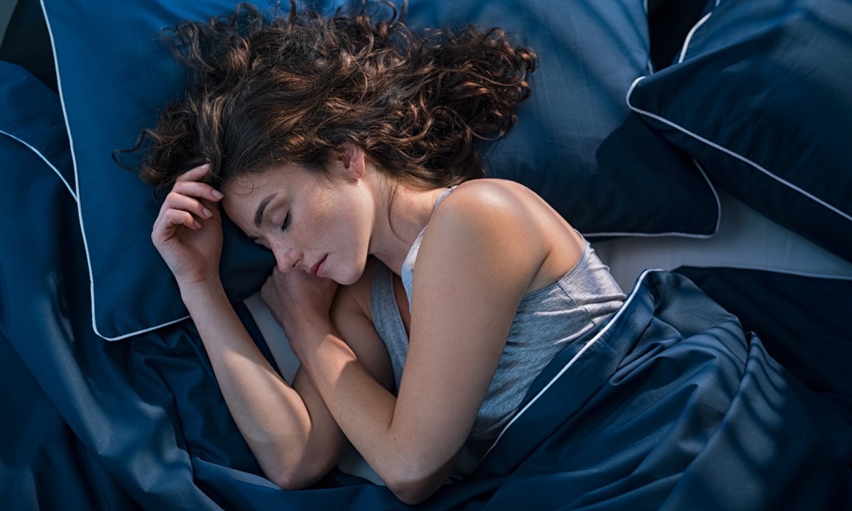 Woman sleeping peacefully, illustrating the connection between sleep and skin health