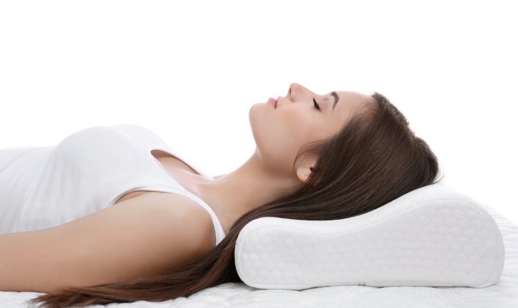 Woman sleeping on her back on a supportive pillow