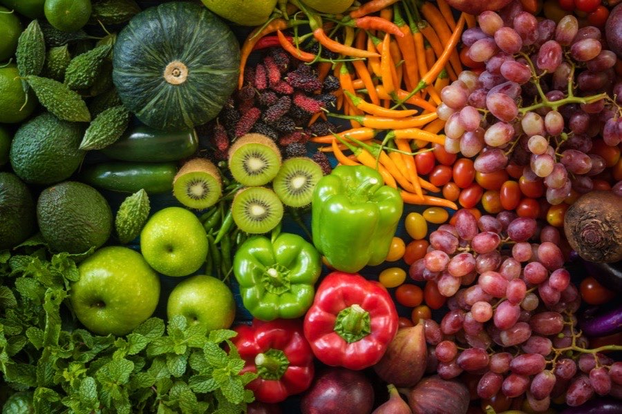 Colorful assortment of fresh fruits and vegetables that support healthy skin